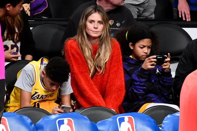 Heidi Klum and her kids Henry Samuel (L) and Lou Samuel attend a basketball game between the Los Angeles Lakers and the Minnesota Timberwolves at Staples Center on January 24, 2019 in Los Angeles, California. (Photo by Allen Berezovsky/Getty Images)