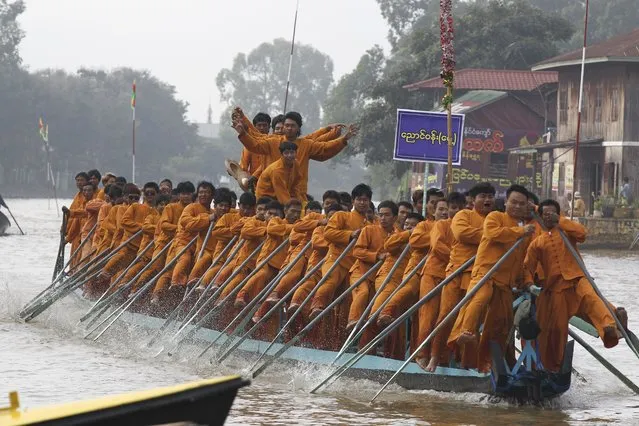 Ethnic Inntha men demonstrate their leg-rowing techniques during a ceremony to mark Inntha National Day Monday, November 13, 2023, in Inle Lake, southern Shan State, Myanmar. (Photo by Thein Zaw/AP Photo)