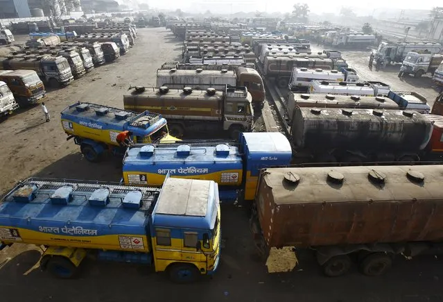 Oil tankers are seen parked at a yard outside a fuel depot on the outskirts of Kolkata in this February 3, 2015 file photo. Asia's oil markets are being upended as India's and China's refiners overtake once-dominant buyers like Japan and challenge the United States as the world's biggest consumer. (Photo by Rupak De Chowdhuri/Reuters)