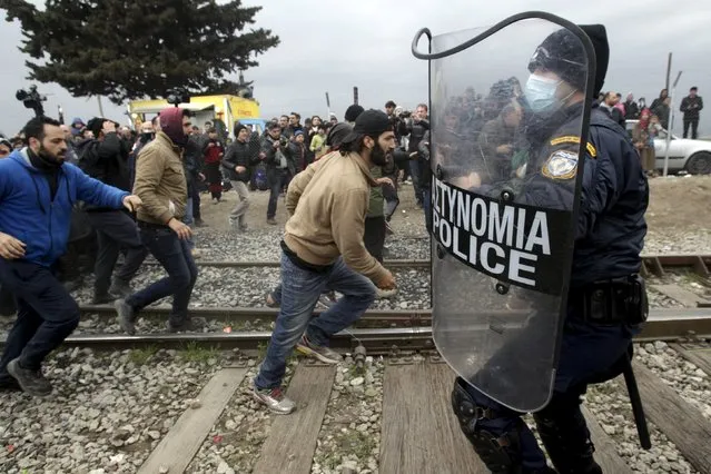 Stranded refugees and migrants try to break a Greek police cordon in order to approach the border fence at the Greek-Macedonian border, near the Greek village of Idomeni, February 29, 2016. (Photo by Alexandros Avramidis/Reuters)