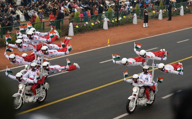 The Indian Military Police' s Dare Devil stunt team take part in a dsiplay during the Republic Day Parade at Rajpath in New Delhi on January 26, 2017. Motorbike stunt riders and herds of camels wowed the crowds gathered in the centre of New Delhi January 26 to celebrate Republic Day, an annual showcase of India' s military hardware and cultural diversity. After the presidents of the United States and France attended the last two extravaganzas, the Crown Prince of Abu Dhabi Mohammed bin Zayed Al Nahyan was this year' s chief guest as everyone from elite troops to schoolchildren paraded down the landmark Rajpath boulevard. (Photo by Prakash Singh/AFP Photo)