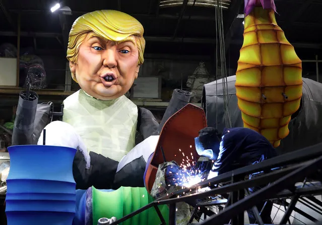 A worker is seen next to a giant figure of U.S. President Donald Trump during preparations for the carnival parade in Nice, France, January 26, 2017. (Photo by Eric Gaillard/Reuters)