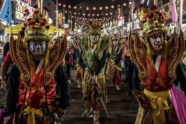 This picture taken on August 31, 2023, The Eight Generals performance during a parade for Chinese Hungry Ghost Festival in Kuala Lumpur. According to Taoist and Buddhist beliefs, the seventh month of the Chinese Lunar calendar, known as the Hungry Ghost Festival is when the Gates of Hell open to let out spirits who wander the land of the living looking for food. Food offerings are made while paper money and joss sticks are burnt to keep the spirits of dead ancestors happy and to bring good luck. (Photo by Mohd Daud/Avalon)