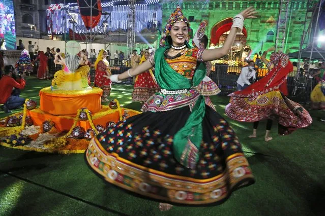 Indians wearing traditional attire perform the Garba, a dance of Gujarat state, to celebrate the Hindu festival Navratri in Ahmedabad, India, Thursday, October 7, 2021. (Photo by Ajit Solanki/AP Photo)