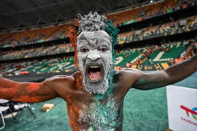 An Ivorian supporter celebrates after winning at the end of the Africa Cup of Nations (CAN) 2024 final football match between Ivory Coast and Nigeria at Alassane Ouattara Olympic Stadium in Ebimpe, Abidjan on February 11, 2024. (Photo by Sia Kambou/AFP Photo)