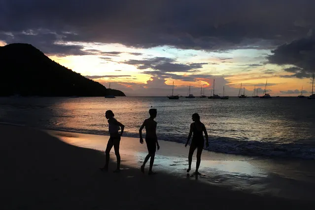 Youths play in the water on the beach of Rodney Bay after sunset in Gros Islet, St. Lucia, November 23,  2016. (Photo by Carlo Allegri/Reuters)