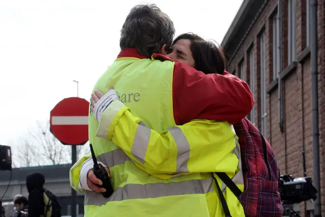 Airport staff comfort each other as passengers are evacuated from Zaventem Bruxelles International Airport after a terrorist attack on March 22, 2016 in Brussels, Belgium. At least 28 people are though to have been killed after Brussels airport  and a Metro station were targeted by explosions. The attacks come just days after a key suspect in the Paris attacks, Salah Abdeslam, was captured in Brussels. (Photo by Sylvain Lefevre/Getty Images)