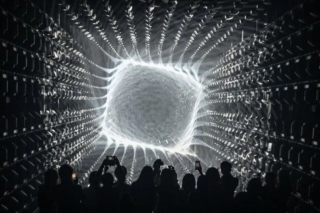 Visitors watch a light display during a tour of the new location for the digital art of Japanese collective “teamLab” at the recently opened 325-metre Azabudai Hills tower in Tokyo on February 5, 2024, ahead of the public opening on February 9. The previous loation of “teamLab Borderless” held the Guinness World Record for the most-visited museum dedicated to a single art group, with nearly 2.2 admissions in one year. (Photo by Richard A. Brooks/AFP Photo)
