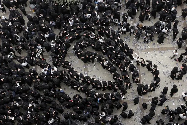Ultra-Orthodox Jewish men dance before the start of a mass prayer in Jerusalem March 2, 2014. Hundreds of thousands of ultra-Orthodox Jews held a mass prayer in Jerusalem on Sunday in protest against a bill meant to slash military exemptions granted to seminary students, a tradition held since the founding of Israel. (Photo by Darren Whiteside/Reuters)