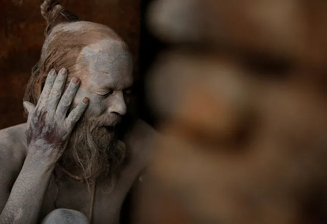 A Hindu holy man, or sadhu, smears ashes on his face at the premises of Pashupatinath Temple, ahead of the Shivaratri festival in Kathmandu, Nepal February 21, 2017. (Photo by Navesh Chitrakar/Reuters)