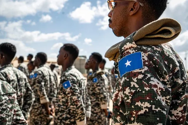A Somali National Army soldier stands at attention during the morning briefing for trainee officers at the General Dhagabadan Training Centre in Mogadishu on March 19, 2024. European Union Training Mission in Somalia (EUTM-S) trainers instruct on a regular basis Somali soldiers on a range of topics, including urban combat, explosive devices detection and disposal, and protective engineering techniques. (Photo by Amaury Falt-Brown/AFP Photo)