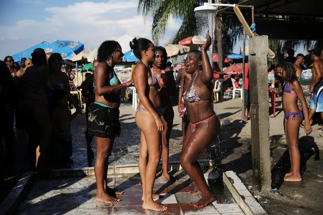 Women shower at an artificial pond known as piscinao, or big pool, in the northern suburbs of Rio de Janeiro, Brazil, January 8, 2017. (Photo by Nacho Doce/Reuters)