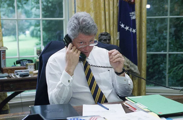 President Bill Clinton speaks via telephone from the Oval Office of the White House to an unidentified member of the House in Washington Thursday, August 11, 1994, lobbying for votes for the crime bill. The White House kept an open telephone line to the Democratic cloakroom so the President could personally woo wavering lawmakers. Willam Jefferson Clinton was the 42nd U.S. President serving from 1993 – 2001. (Photo by Marcy Nighswander/AP Photo)