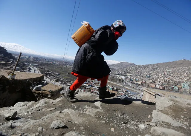 An Afghan girl carries water on her back as she climbs a hill in Kabul, Afghanistan February 20, 2017. (Photo by Omar Sobhani/Reuters)