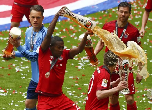 Bayern Munich's David Alaba (L) pours beer over Mitchell Weiser after their final German first division Bundesliga soccer match of the season against FSV Mainz 05 in Munich, May 23, 2015. (Photo by Michaela Rehle/Reuters)