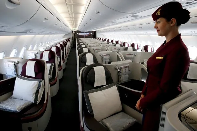 A Qatar Airways crew member presents the business class seats of an Airbus A380 aircraft during the 51st Paris Air Show at Le Bourget airport near Paris June 17, 2015. REUTERS/Pascal Rossignol 