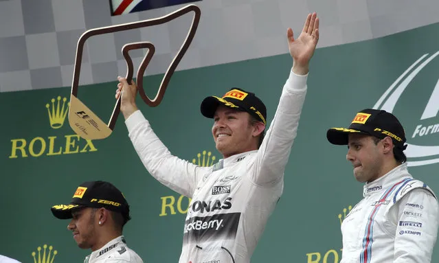 Mercedes driver Nico Rosberg, center, of Germany celebrates his victory with second placed Mercedes driver Lewis Hamilton, left, of Britain and third Williams driver Felipe Massa, right, of Brazil at the victory ceremony of the Austrian Formula One Grand Prix race in Spielberg, southern Austria, Sunday, June 21, 2015. (AP Photo/Ronald Zak)