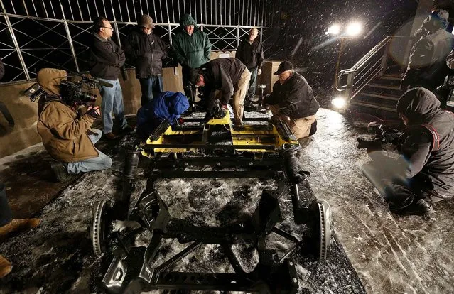 Workers reassemble the 2015 Ford Mustang convertible overnight on the observation deck of the Empire State Building. (Photo by Hiroko Masuike/The New York Times)