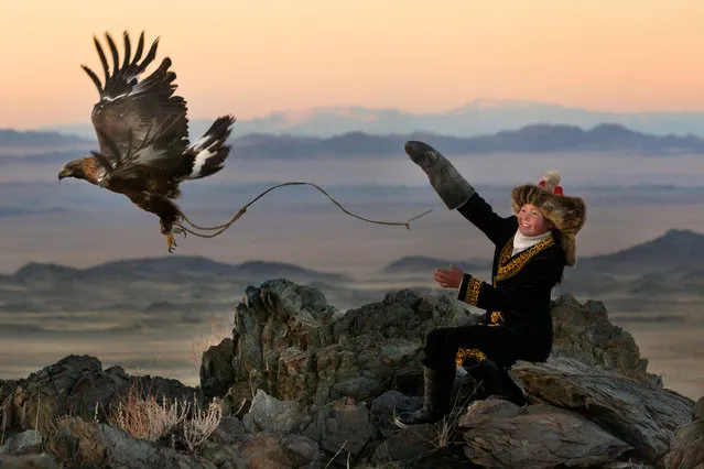 13 year old Ashol Pan with her eagle – Despite her young age, Ashol had the amazing ability to control and be able to caress her eagle, almost as if she had been with it for years. (Photo by Asher Svidensky/Caters News)