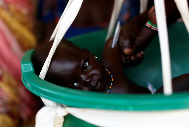 A baby is weighted on a scale in a health clinic in the capital Juba, South Sudan, January 23, 2017. (Photo by Siegfried Modola/Reuters)