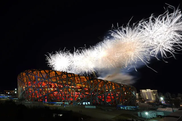 Fireworks explode during the opening ceremony of the 2022 Winter Olympics, Friday, February 4, 2022, in Beijing. (Photo by Brynn Anderson/AP Photo)