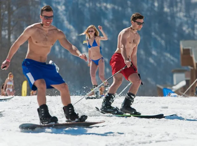 People dressed in swimsuits participate in the BoogelWoogel alpine carnival at the Rosa Khutor Alpine Resort in Krasnaya Polyana, Sochi, Russia on April 1, 2017. (Photo by Artur Lebedev/TASS)