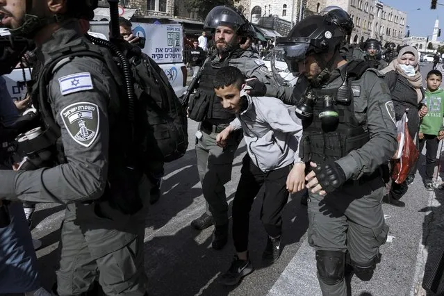 Israeli border police officers detain a Palestinian youth next to Damascus Gate just outside Jerusalem's Old City, Monday, February 28, 2022. Israeli police arrested 20 people during clashes in east Jerusalem Monday, highlighting tensions during a Muslim holiday celebration. Four officers were injured, the police said. Red Crescent said 33 people were injured and five of them were transferred to a hospital. (Phoot by Mahmoud Illean/AP Photo)