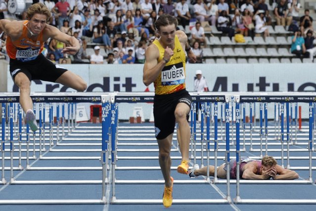 France's Kevin Mayer (R) reacts after falling in the men's 110m hurdles triathlon event during the “Meeting de Paris” Diamond League athletics meeting at the Charlety Stadium in Paris on July 7, 2024. (Photo by Geoffroy Van der Hasselt/AFP Photo)