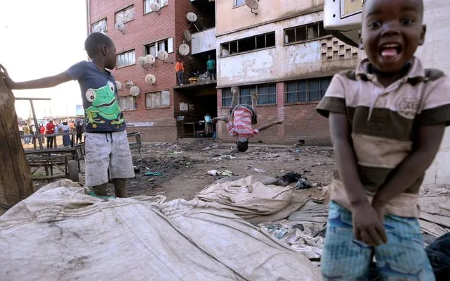 Children play at a block of flats in Harare,Tuesday, September 10, 2019. Former Zimbabwean President Robert Mugabe who died aged 95 in Singapore is expected to be buried on Sunday according to state media. Zimbabwean President Emmerson Mnangagwa declared him a national hero. (Photo by Tsvangirayi Mukwazhi/AP Photo)