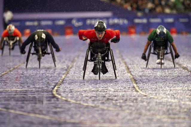 Paralympic athlete Fabian Blum, of Switzerland, competes at Men's 400m - T52 round 1, at the Stade de France stadium, during the 2024 Paralympics, Friday, August 30, 2024, in Paris, France. (Photo by Emilio Morenatti/AP Photo)