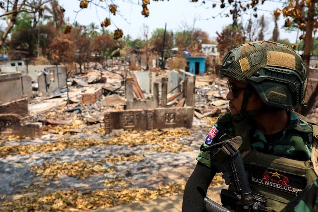 A soldier from the Karen National Liberation Army (KNLA) patrols on a vehicle, next to an area destroyed by Myanmar's airstrike in Myawaddy, the Thailand-Myanmar border town under the control of a coalition of rebel forces led by the Karen National Union, in Myanmar, on April 15, 2024. (Photo by Athit Perawongmetha/Reuters)