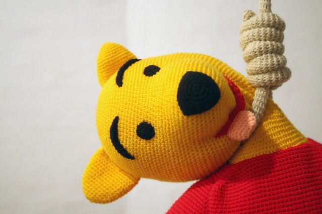 The knitted sculpture 'Winnie Pooh' by Patricia Waller, featuring the children's book character as a suicide victim, hangs in the 'Broken Heroes' exhibition at the Deschler Gallery