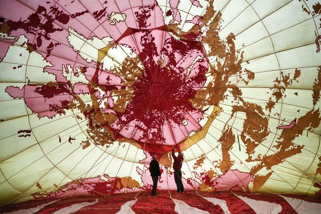 Balloonists inflate the canopy of the BBC balloon at the start of the the three day Midlands Air Festival at Ragley Hall on June 02, 2023 in Alcester, England. The BBC balloon was featured in the television channel's ident on BBC One between 1997 and 2002.  The balloon has been restored by brothers Liam and Daniel Whitelock to make it ready to be flown during the Midlands Air Festival.The festival returns for its fifth year, featuring displays by the Royal Air Force’s Aerobatic team, the Red Arrows, and the Typhoon, the RAF's frontline fighter jet, who will performing their first displays of the air show season.  (Photo by Christopher Furlong/Getty Images)