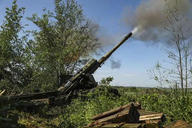 A 2A36 Giatsint-B, a Soviet/Russian towed 152 mm field gun, is fired by self-proclaimed Donetsk People's Republic (DPR) militia on the frontline near Avdiivka, Donetsk region, eastern Ukraine, 02 June 2022. On 24 February Russian troops had entered Ukrainian territory in what the Russian president declared a “special military operation”, resulting in fighting and destruction in the country and a humanitarian crisis. (Photo by Alessandro Guerra/EPA/EFE)