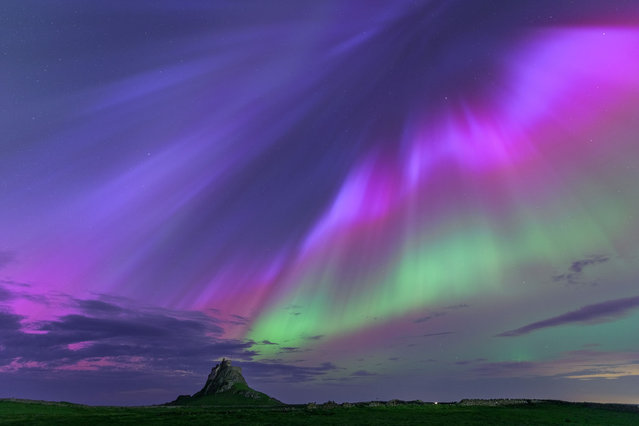 The aurora borealis, viewed above the island of Lindisfarne, off the northeast coast of England, on May 11, 2024. (Photo by John Finney/WENN)