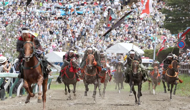 Participants clad in Japan's traditional samurai armor race in the Kacchu Keiba or the Armor Horse Racing during the annual Soma Nomaoi festival in Hibarigahara field in Minamisoma in Fukushima Prefecture, northeastern Japan, Sunday, July 30, 2017. The racing, competed by 12 horsemen over the distance of 1,000-meter (1,100-yard), is the main event of the 1,000-year-old festival jointly organized by three shrines in Soma, a famous horse-breeding district in Fukushima. (Photo by Jun Hirata/Kyodo News via AP Photo)