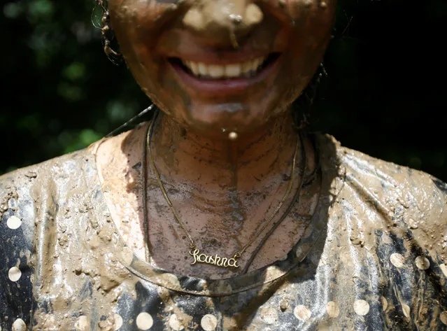 A student of Himalayan Agriculture College with a gold locket that reads her name ÒRashnaÓ is covered in mud while celebrating Asar Pandra festival in Lalitpur, Nepal, June 29, 2016. (Photo by Navesh Chitrakar/Reuters)