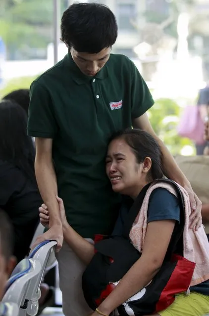 Relatives react after seeing the body of Yutnarong Singraw, a victim of Monday's bomb blast, at the Institute of Forensic Medicine in Bangkok, Thailand, August 18, 2015. (Photo by Chaiwat Subprasom/Reuters)