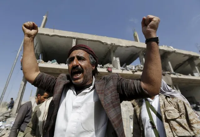 A Houthi militant reacts in front the offices of the education ministry's workers union, destroyed by Saudi-led air strikes, in Yemen's northwestern city of Amran August 19, 2015. (Photo by Khaled Abdullah/Reuters)