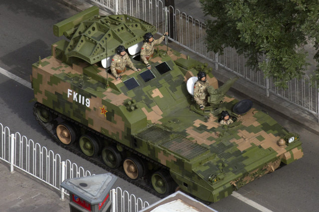 A Chinese armored vehicle leaves after rehearsals ahead of the Sept. 3 military parade to commemorate the end of World War II in Beijing, Sunday, August 23, 2015. (Photo by Ng Han Guan/AP Photo)