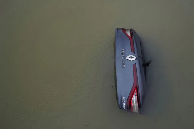 A car is submerged following heavy rainfall and snow melt in Zorrotza, Spain, November 29, 2021. (Photo by Vincent West/Reuters)