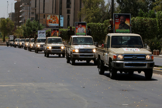 Vehicles of the Hashid Shaabi (Popular Mobilization) take part in a military parade in the streets of Baghdad, Iraq July 12, 2016. (Photo by Khalid al Mousily/Reuters)