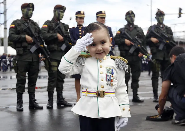 Gabriela Gomez, 3, poses for a photo decked out in a military costume before the start of a military parade celebrating her country's 206th anniversary of independence from Spain, in Bogota, Colombia, Wednesday, July 20, 2016. (Photo by Fernando Vergara/AP Photo)
