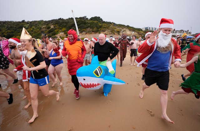 Swimmers take part in the Macmillan Boscombe White Christmas Dip, in aid of Macmillan Caring Locally, at Boscombe Pier in Bournemouth, Dorset, UK on Wednesday, December 25, 2024. (Photo by Andrew Matthews/PA Images via Getty Images)