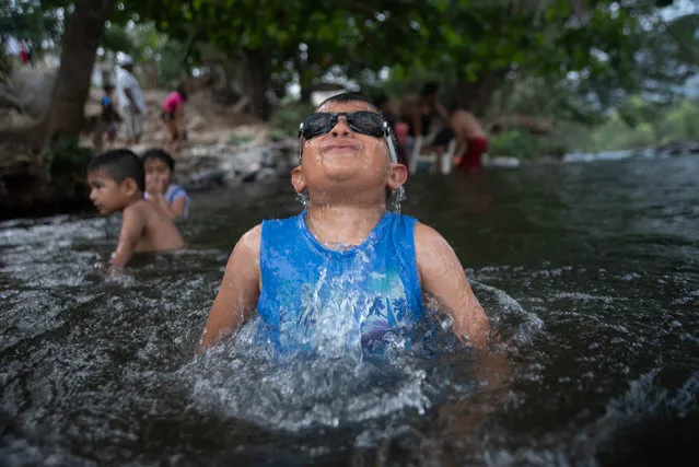 Local children and their families take advantage of the fact that there are no tourists in their town to enjoy the waters of the River, closed to prevent the spread of COVID-19 in Veracruz, México on April 9, 2020. This is how the inhabitants pass the quarantine. (Photo by Hector Adolfo Quintanar Perez/ZUMA Wire/Rex Features/Shutterstock)