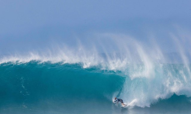 Kelly Slater of the USA rides a wave during the WSL Lexus Pipe Pro men's event at Pipeline on the North Shore of Oahu, Hawaii, February 7, 2025. Kelly Slater, 11-time world surfing champion, wins his heat and advances to tomorrow's quarter-finals on the final day. (Photo by Brian Bielmann/AFP Photo)