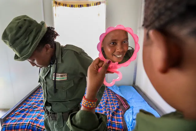 Eunice Peneti (R), 28, a former athelete and one of the eight members of the first Kenyan female Maasai community ranger’s unit known as 'Team Lioness', has a final look into the mirror prior to go on patrol within the Olulugului-Olareshi group ranch, an expansive area of traditional Maasai community land in Amboseli, Kajiado, Kenya, on 16 May 2020. The female rangers are part of a total of 76 community rangers who are financed by the International Fund for Animal Welfare (IFAW), and patrol a route of at least 20 kilometres every day to look out for any illegal activity or injured animals as a way of preventing poaching and reducing human wildlife conflict. Their patrol area is part of the 607 square kilometres of communal land around Amboseli National Park in visual range of Mount Kilimanjaro in Tanzania, the highest peak in Africa. The park is also a passageway for thousands of elephants in the middle of Maasai land. Due to the COVID-19 coronavirus pandemic, the lioness team members have not been able to go home since early March 2020 and the team has been living in their camps as a preventive measure to stop the spread of the virus and from contracting the virus. The closure of borders and the threat of the coronavirus has emptied the Kenyan parks, the main tourist attraction in the country, affecting also the Maasai communities that are highly depending on their income from the tourism – either in formal jobs, by selling small jewels to tourists or even by a small fee from tourists visiting their 'boma', the circular mud house villages where most of this ethnic group live. The IFAW funded rangers had to increase their patrols to ensure that poachers do not exploit any gaps that may arise leading to an increase in poaching. (Photo by Daniel Irungu/EPA/EFE)