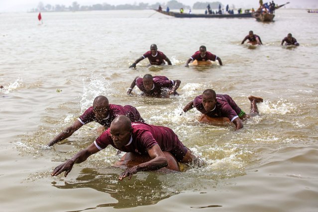 Participants use round gourds to navigate during the annual boat regatta in Yauri, Kebbi State, on February 15, 2025. (Photo by Toyin Adedokun/AFP Photo)
