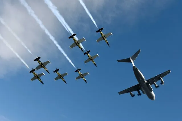 Seven L-39c Albatros aircraft from the Breitling Jet Team in the process of joining up for a formation flight with the latest offering from Airbus over Toulouse, France, on Saturday, September 20, 2014. The Airbus A400M is a strategic military aircraft for Intercontinental or long range missions, with also the ability to bring relief for humanitarian efforts to remote, dangerous or inhospitable regions around the globe.(Photo by Katsuhiko Tokunaga/Breitling via AP Images)