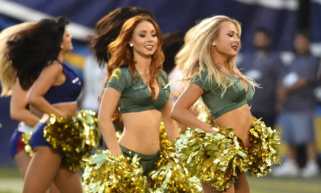 San Diego Chargers cheerleaders entertain during the first half of a preseason NFL football game against the Dallas Cowboys Thursday, August 7, 2014, in San Diego. (Photo by Denis Poroy/AP Photo)